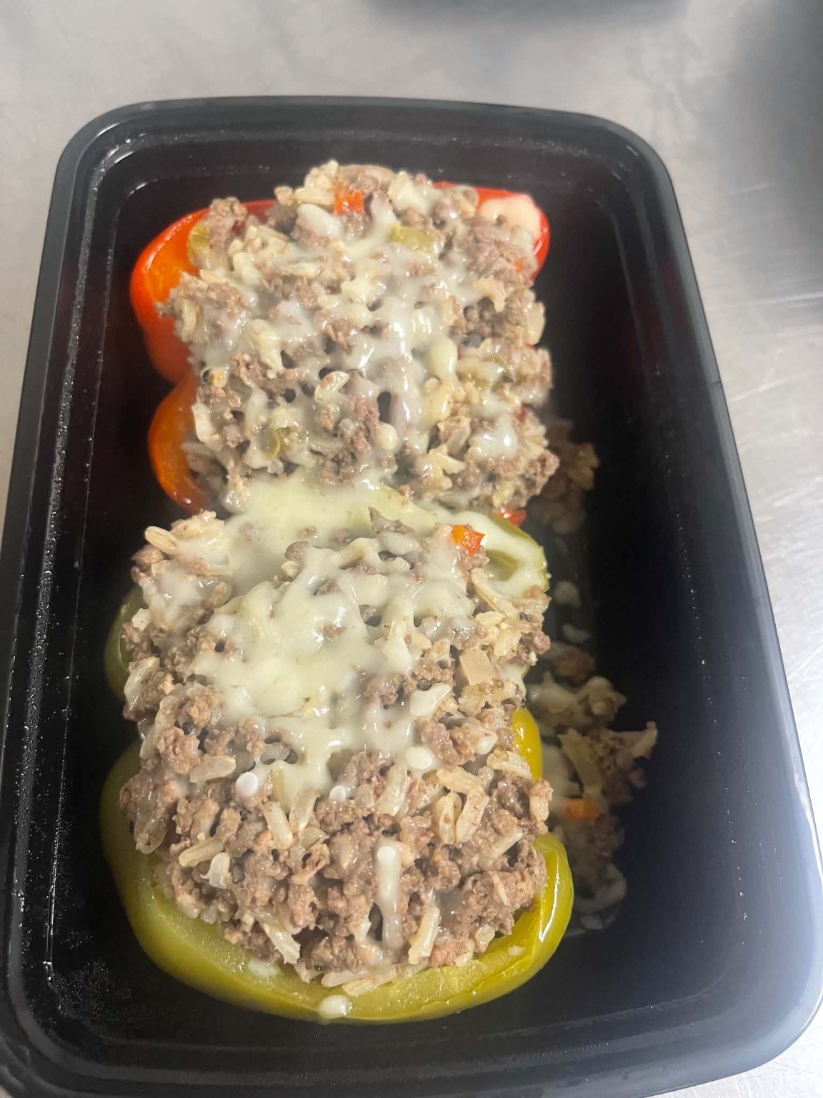 Stuffed bell peppers topped with melted cheese